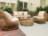 Outdoor seating with rattan furniture set in a lush garden patio, ideal for relaxation and gatherings.