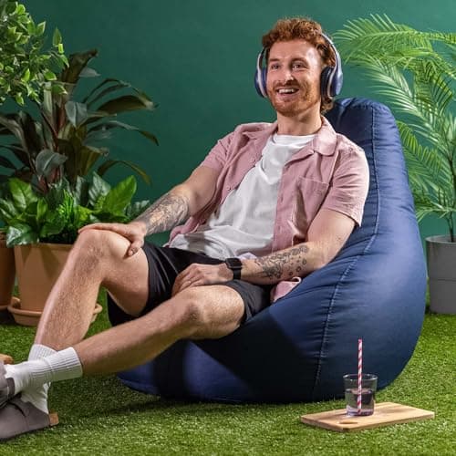 Homme souriant assis sur pouf poire bleu marine