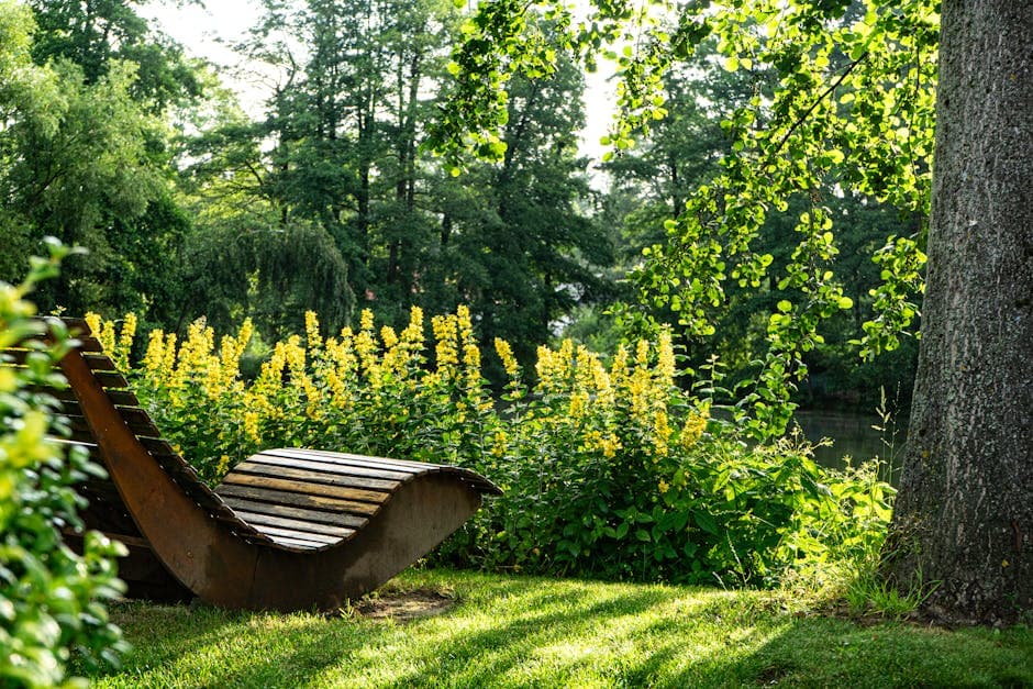 A serene garden scene featuring a wooden lounger surrounded by lush greenery and yellow flowers.